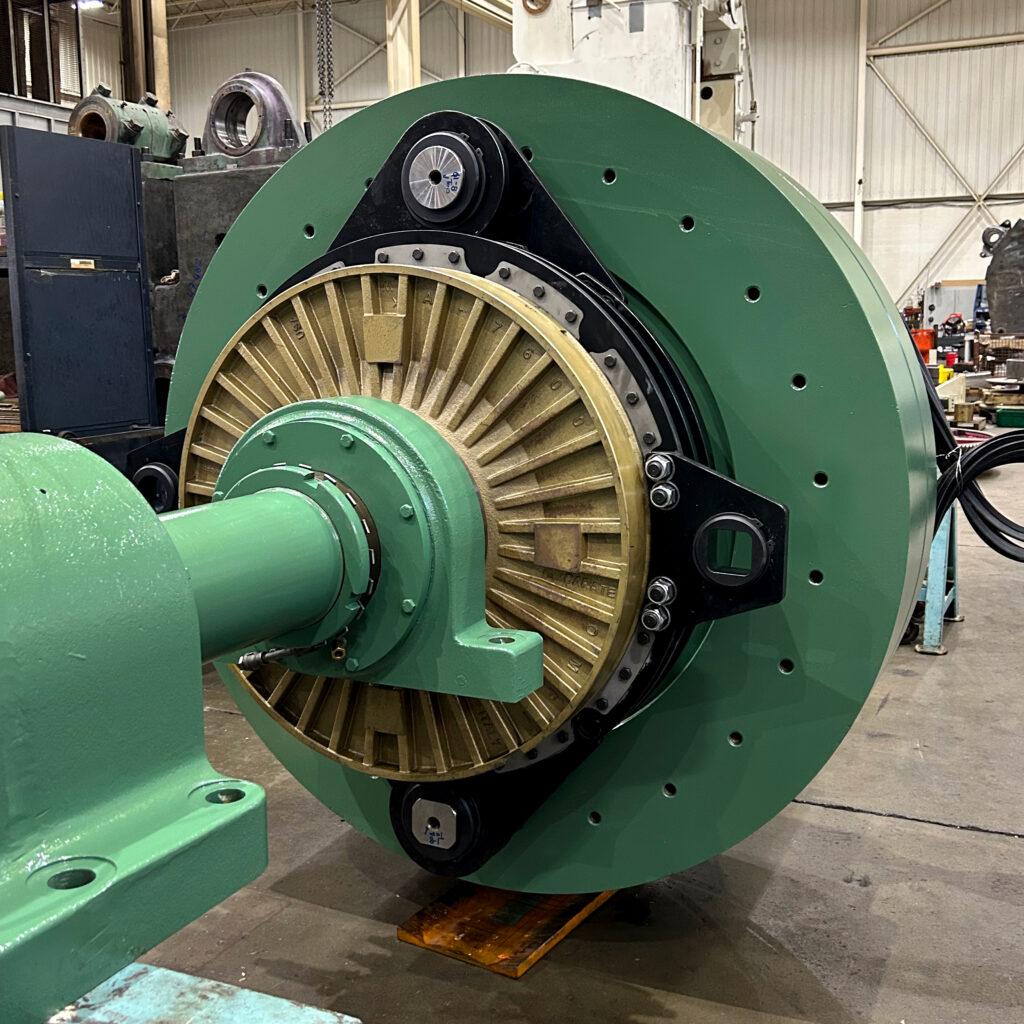 Converted industrial clutch assembly with updated green flywheel, bronze clutch housing, and new mounting hardware.