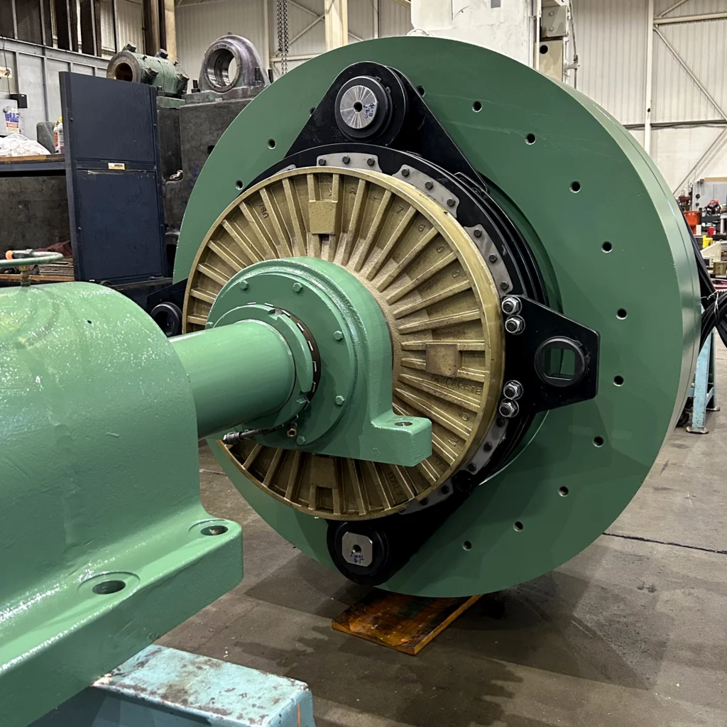 Converted industrial clutch assembly with updated green flywheel, bronze clutch housing, and new mounting hardware.